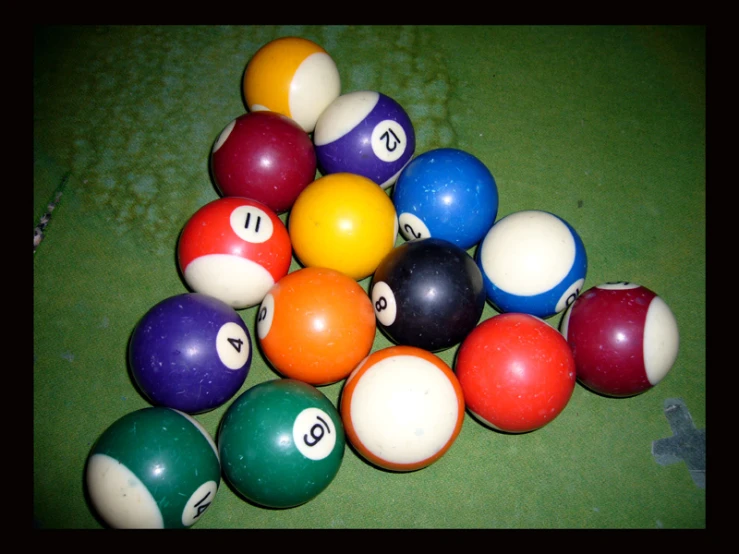 a table with a bunch of billiard balls and numbers
