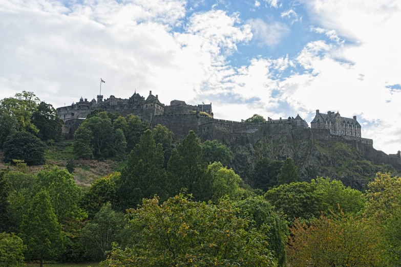 a castle sitting on top of a green hill