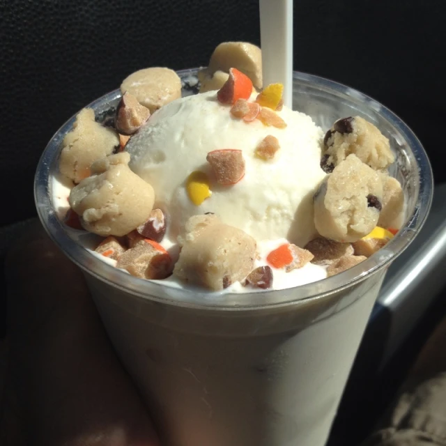 an ice cream sundae in a container on a table