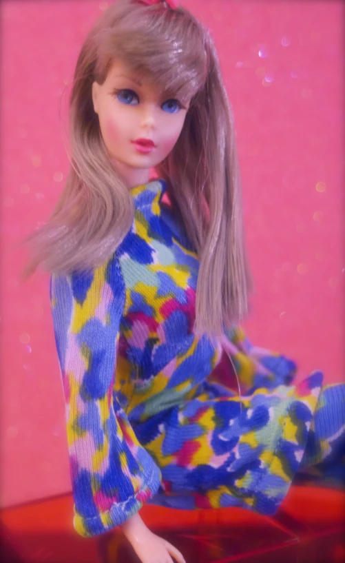 a barbie doll is wearing brightly colored clothing