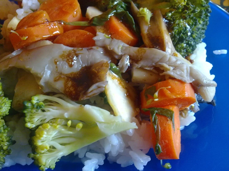 a plate of food with vegetables, meat and rice