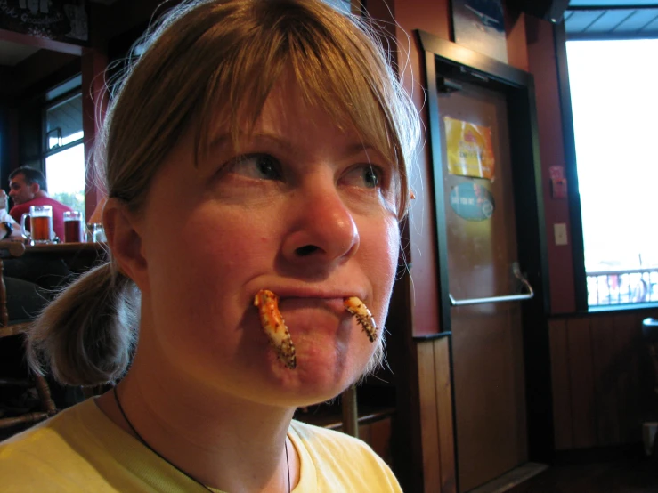girl with a piece of food in her mouth