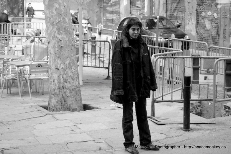 a man stands in the rain on a city street