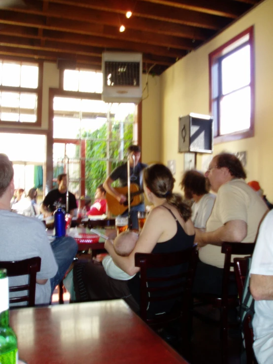 people at tables are in a small dining room