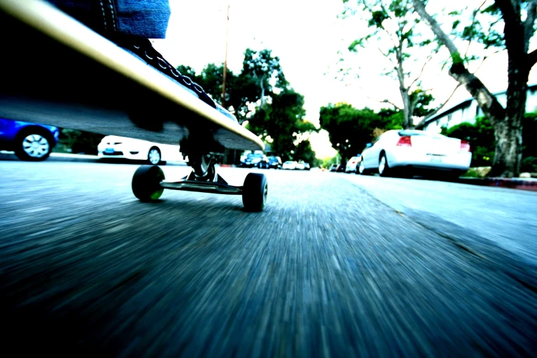 the foot of a skateboard in motion on a city street