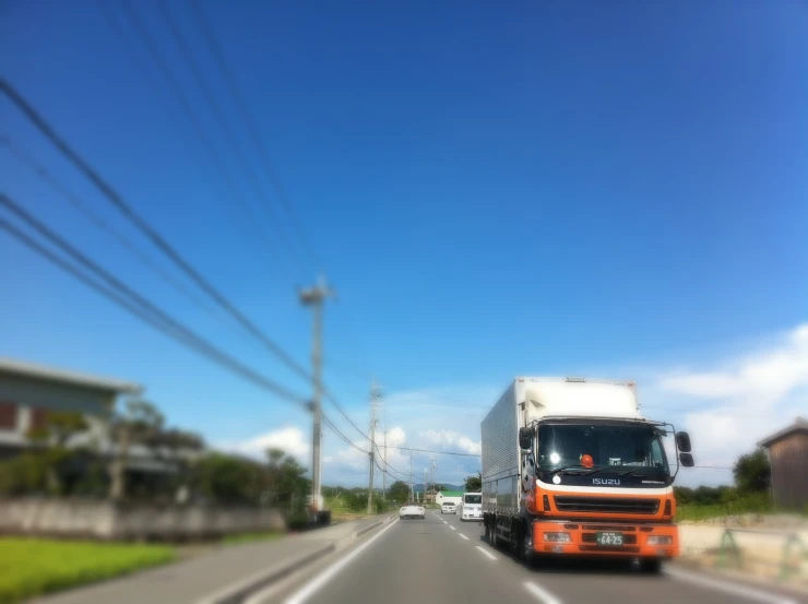 a view of a truck from inside the truck in the middle of the road