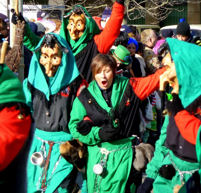 several people in costumes are holding hands in the air