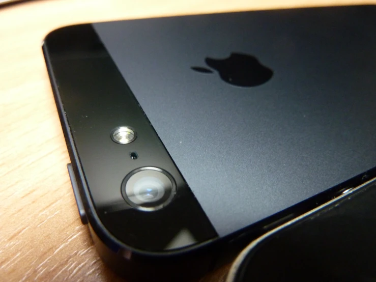 a black ipod phone sitting on top of a table