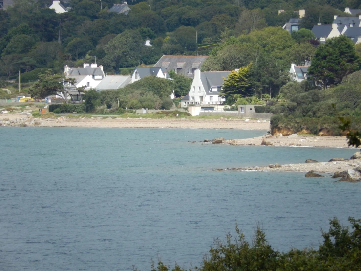 some houses on a hillside near the water