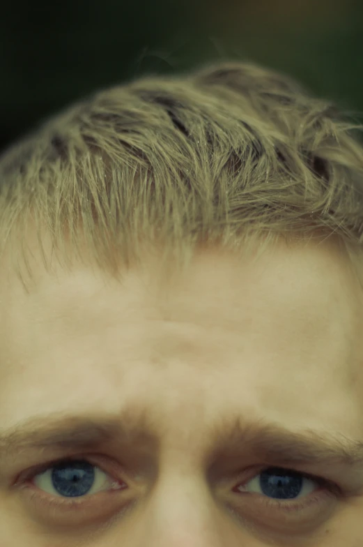 a young man's eyes and hair are covered with frizz