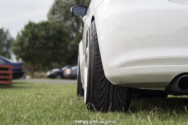 the back tire of a car sitting in the grass
