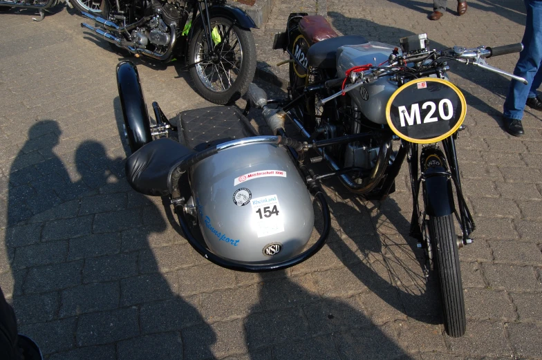 motorcycle, car and sidecar parked in the street