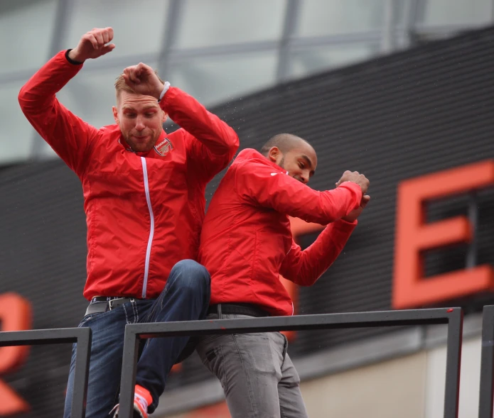 two men are dancing in front of a sign