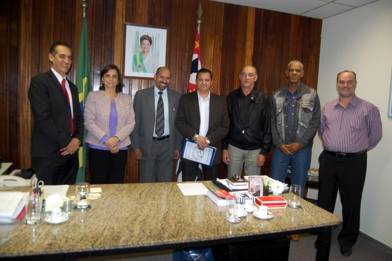 several men standing together in an office smiling