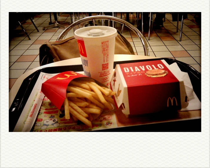 the tray is full of fries and a drink