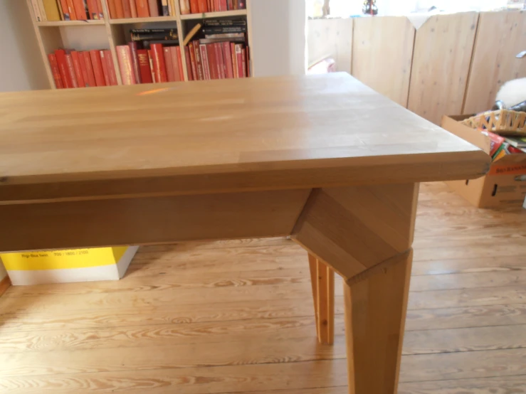 a wooden table and bookshelf sitting in front of a door