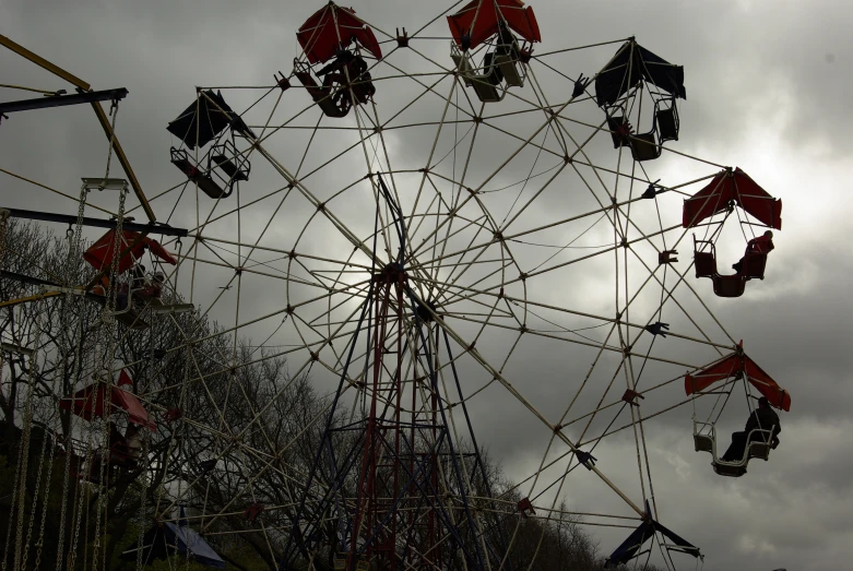 an amut carousel in front of some very cloudy skies