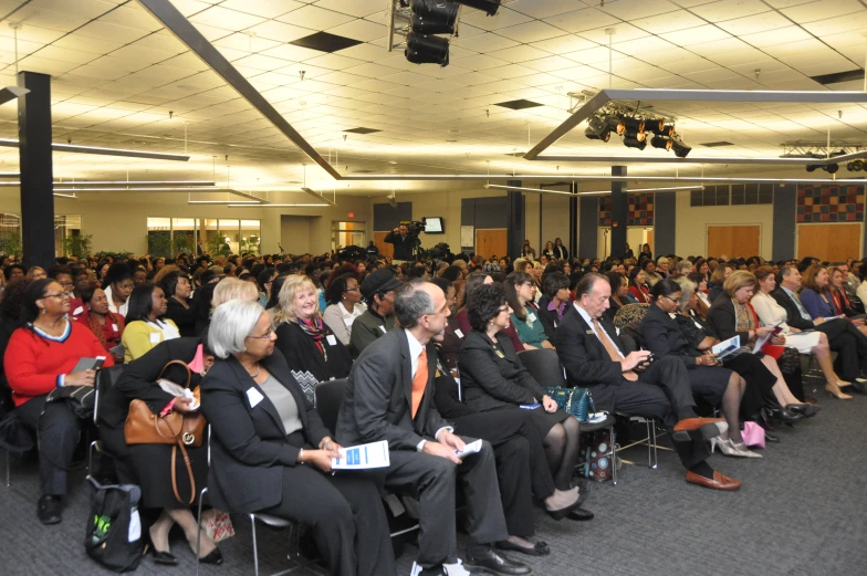 a group of people are sitting in chairs with suits on