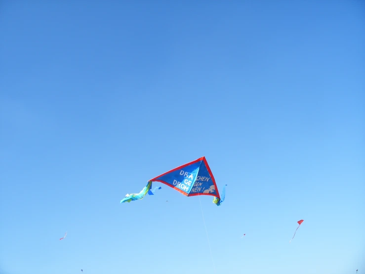 several kites are flying in the sky