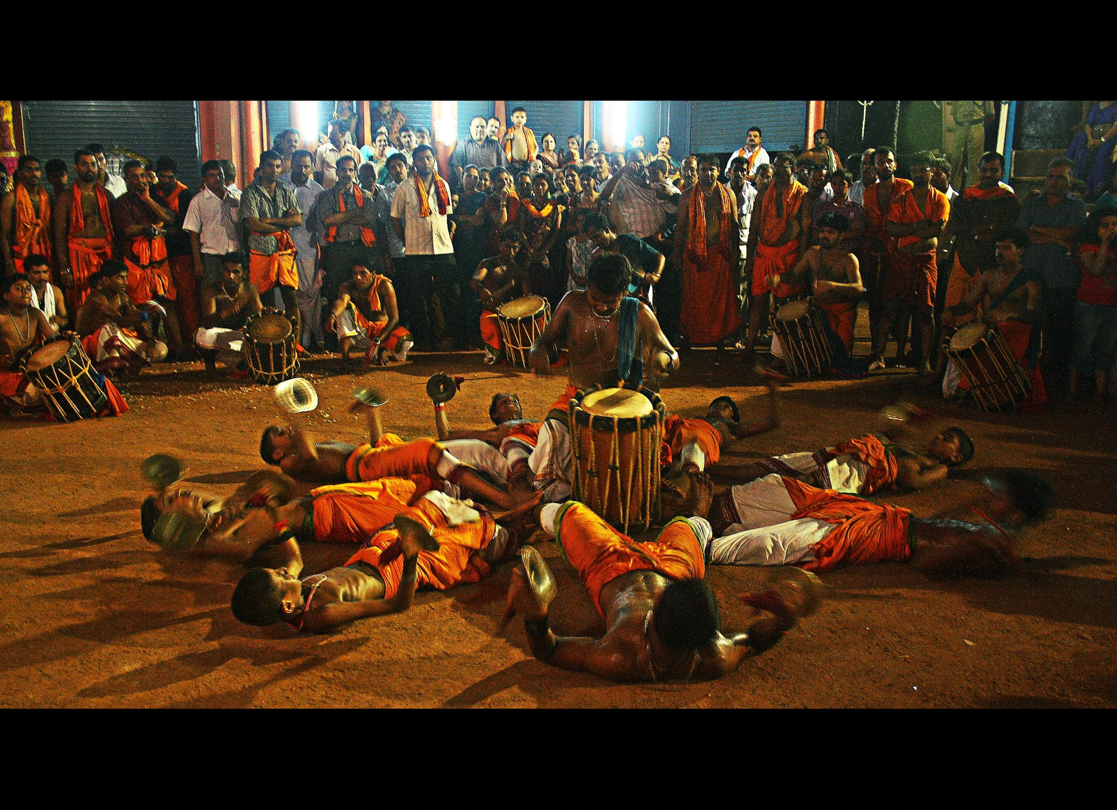 people are sitting on the ground with drums