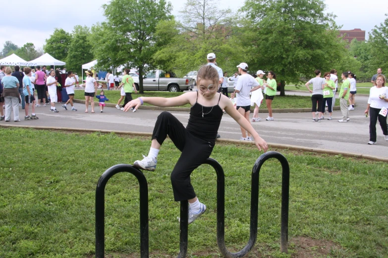 a  is balancing on some black metal railing