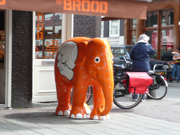 an elephant statue on the side of a street