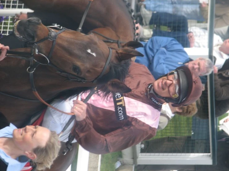 a jockey riding on the back of a horse