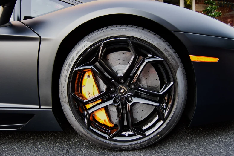 a sports car with golden rims and yellow tires