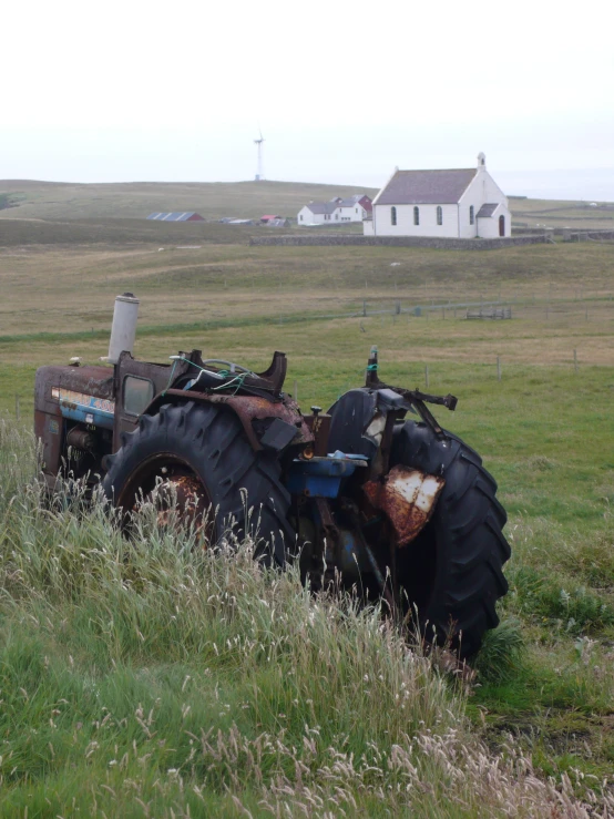 a large tractor parked in a grassy field