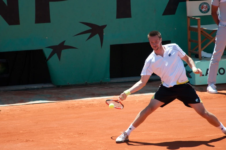 a tennis player is holding up his racket to hit the ball