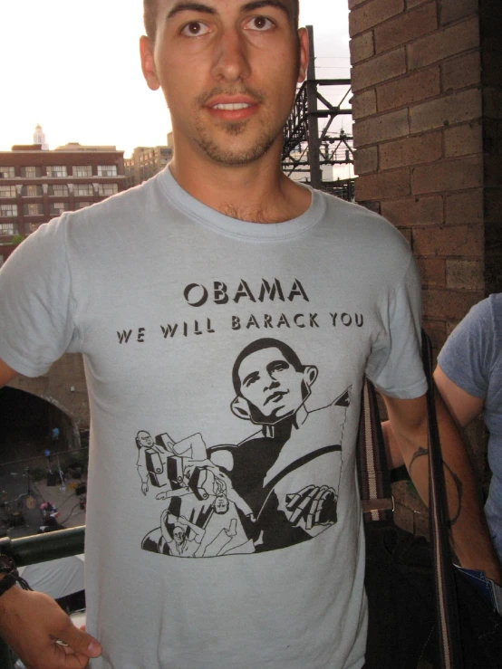 the man is wearing obama shirt with barack on it