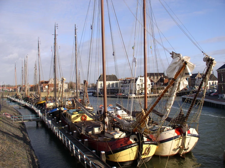 a row of boats in the water tied together