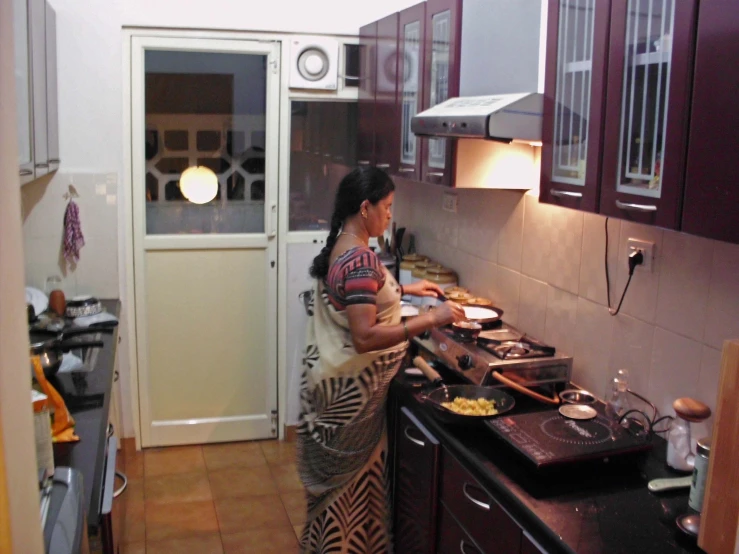 an image of a woman cooking in the kitchen