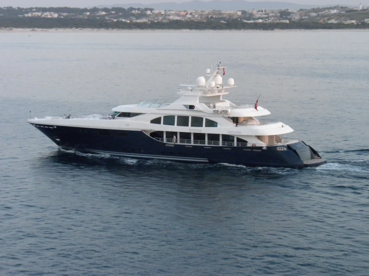 a boat is on the water with buildings behind it