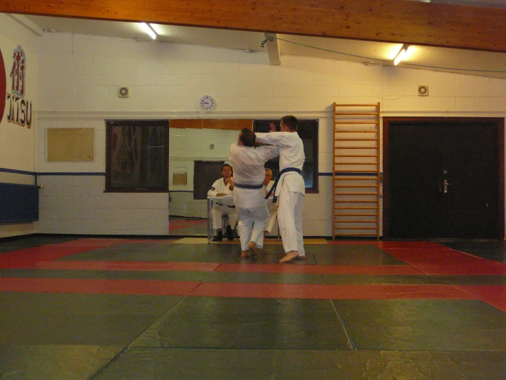 two men on a floor doing karate
