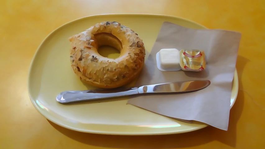 a table topped with a plate with a donut and two slices of cake