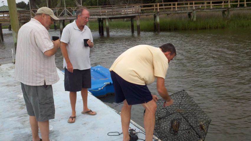 a couple of men standing on a boat