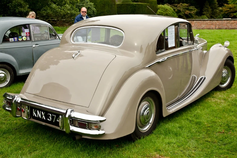 two cars that are sitting on a green field