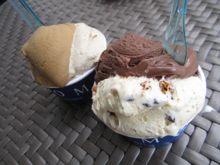 two scoops of ice cream on a tiled surface