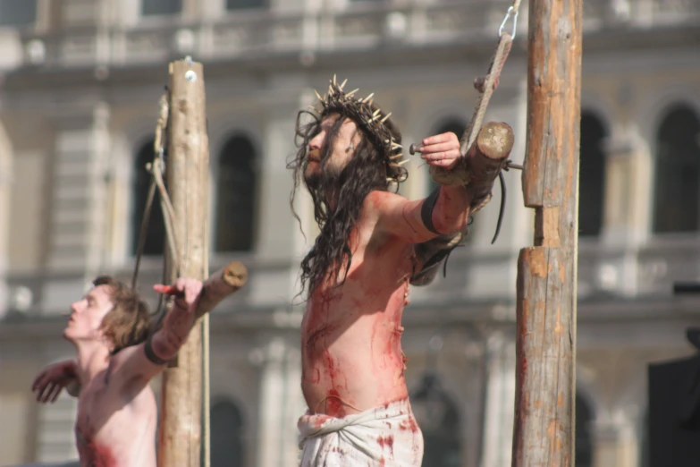 a man with dreadlocks holding a cross