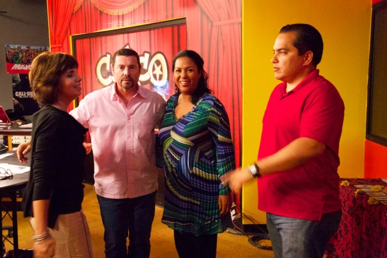 a man is greeting three people at the event