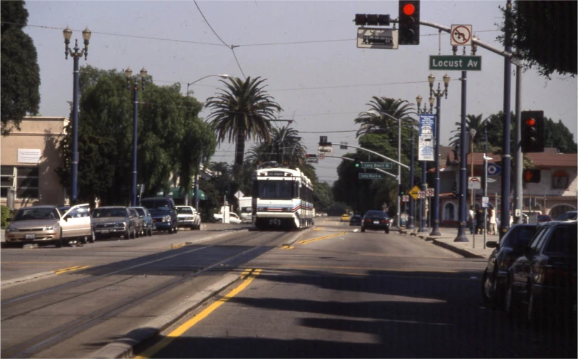 a road with cars and a bus driving down it