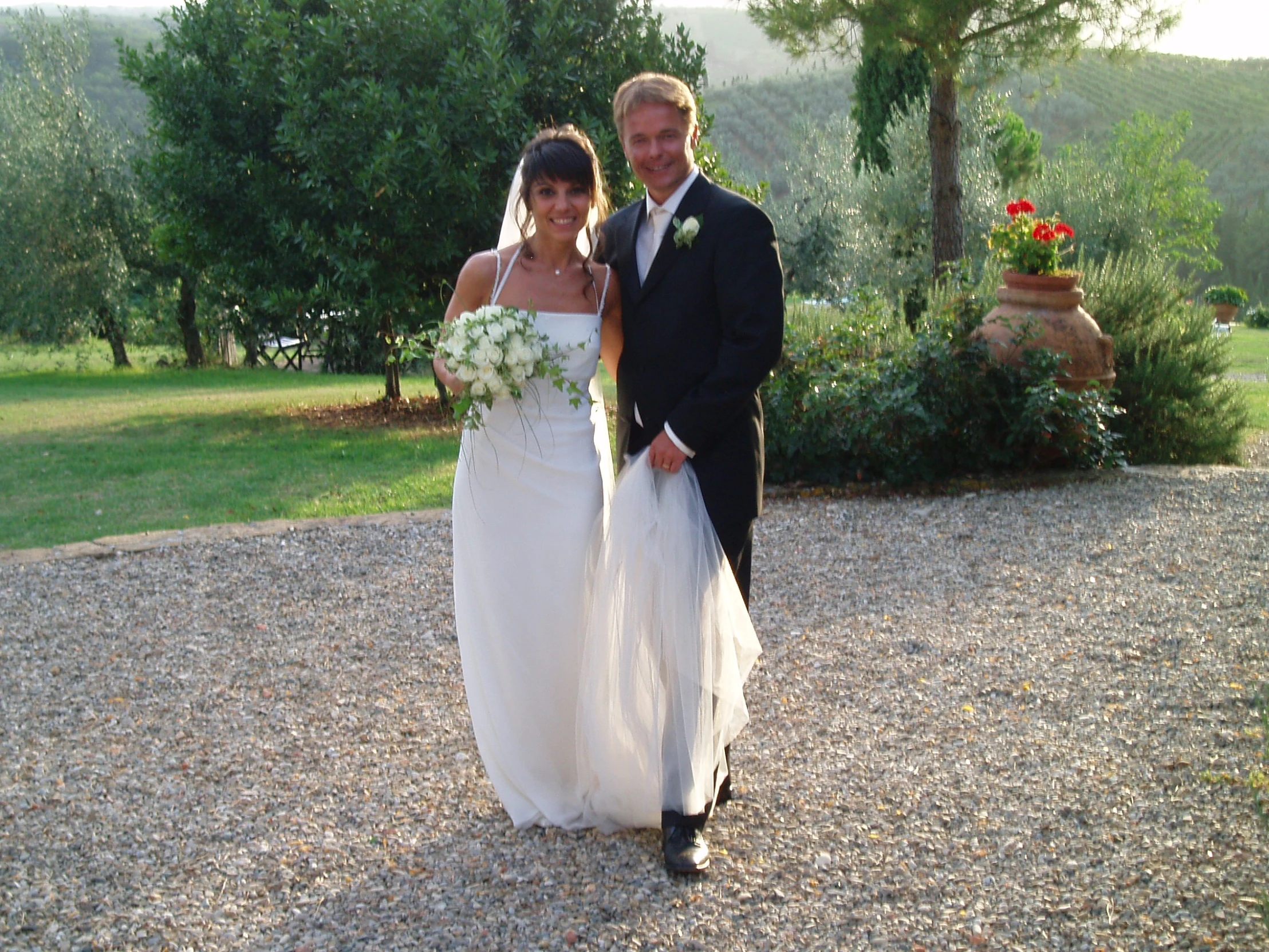 a bride and groom posing for a pograph