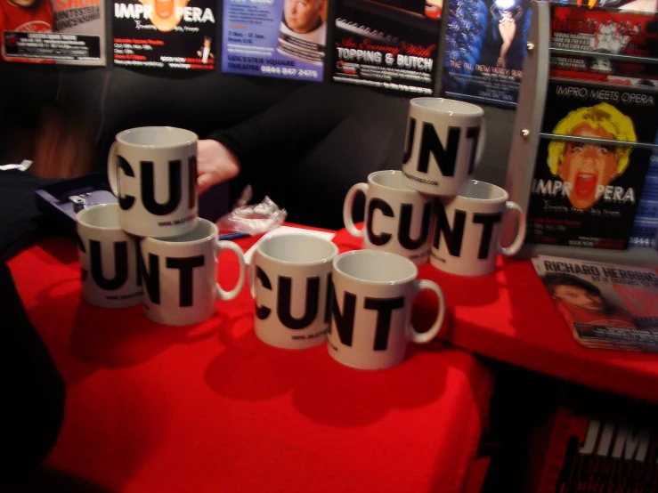 seven coffee mugs reading no condt and one saying on the cups