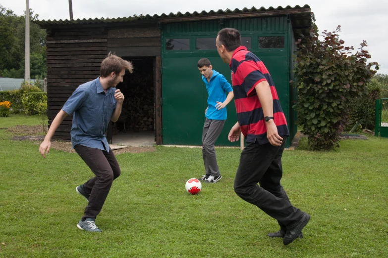 men play soccer on an open field