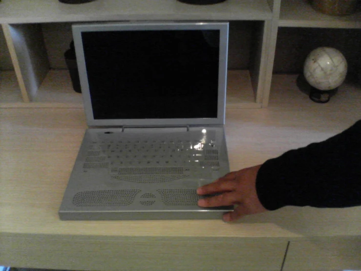 a person pressing keys on a laptop computer
