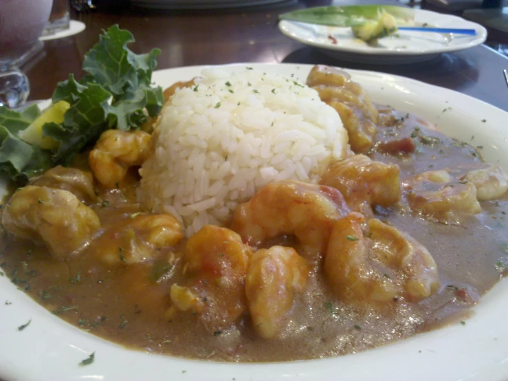 a plate topped with rice and some type of food