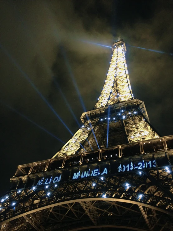 eiffel tower lit up in blue at night