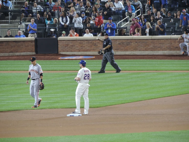 a batter prepares to bat while a group of baseball players await