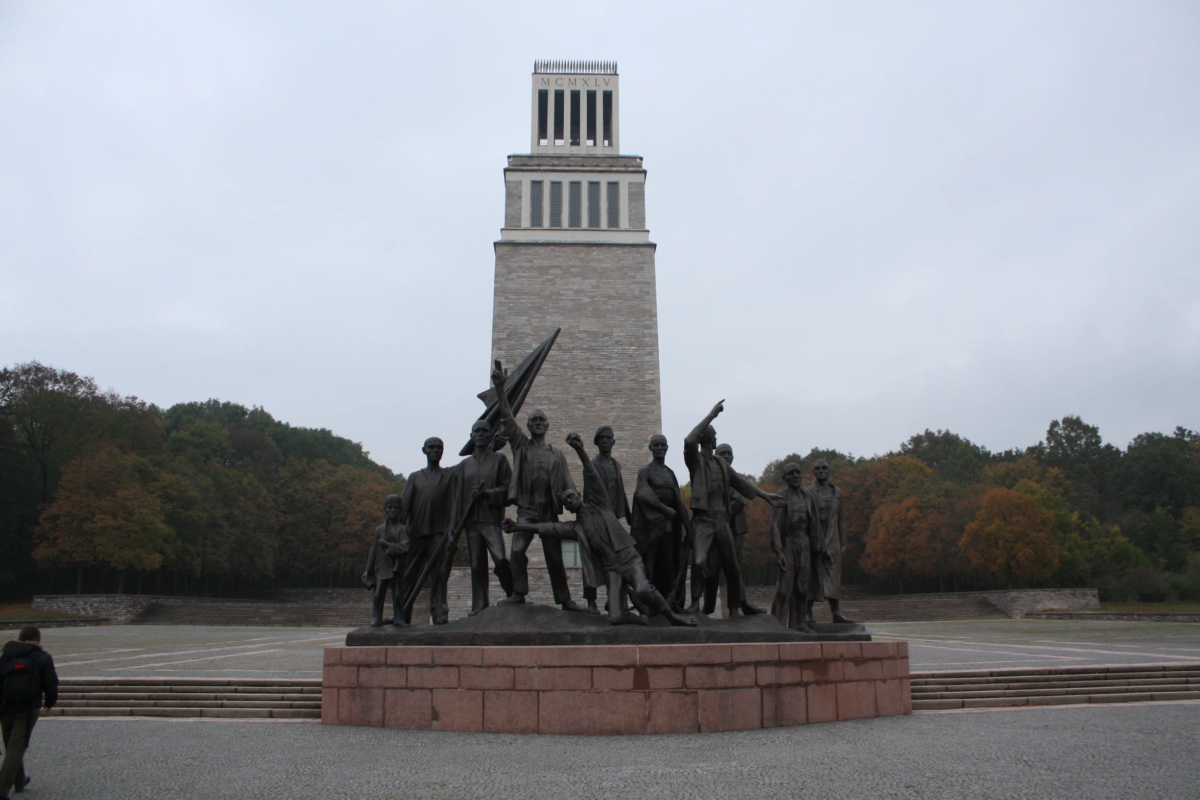 a group of men and women standing on a pedestal